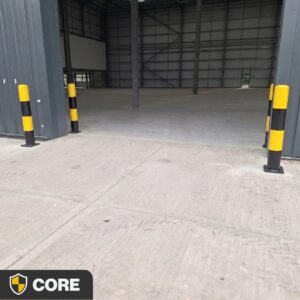 Black and yellow ImpactCORE Bollard for visible asset and infrastructure protection in industrial environments