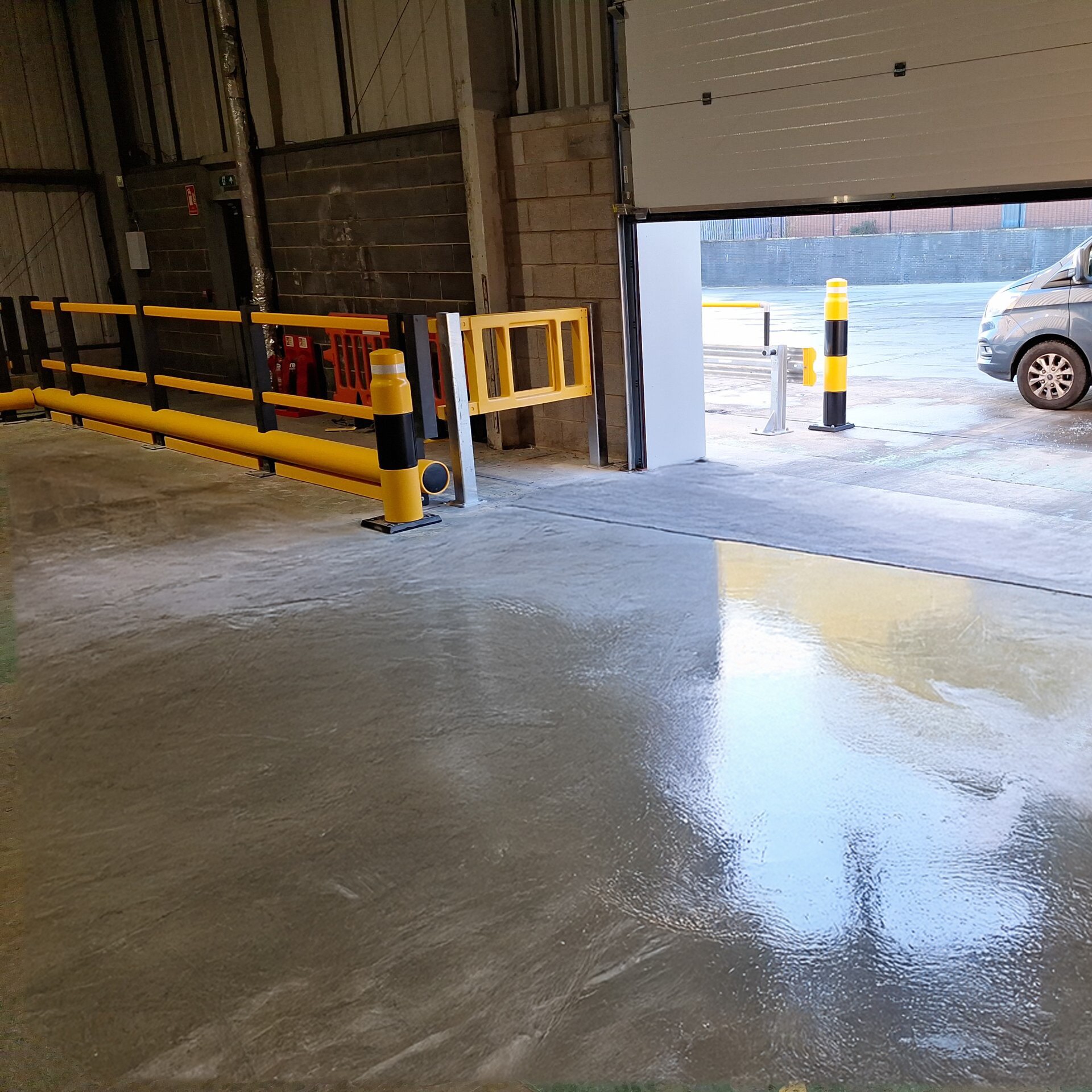 Floor Rail Bumpers Under Polymer Barriers with Heavy Duty Bollards.jpg