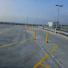 Yellow ImpactSAFE safety posts installed at the end of parking bays in a multi storey car park to prevent vehicle impact damage.