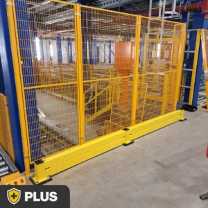 Low level guardrail system positioned in front of a metal mesh safety partition to protect machinery and facility infrastructure from vehicle impacts.