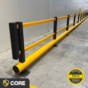 Long run of polymer Single Bumper Pedestrian Barrier separating an office walkway from warehouse operations at a logistics warehouse, shown with PAS 13 and Core Range logos.