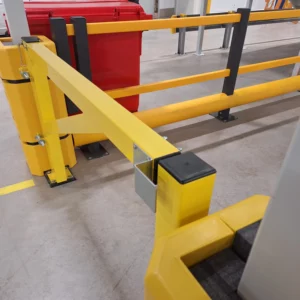 Closed yellow metal transit gate showing its latch and black plastic end caps
