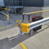 Armco 760HR safety barrier installed around a warehouse corner fire point to protect critical emergency equipment from vehicle damage.